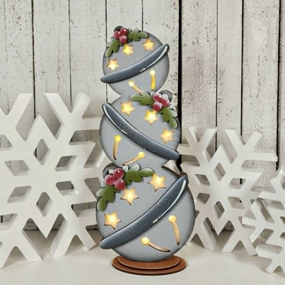 Decorative lamp with spiral design and floral elements on a wooden background
