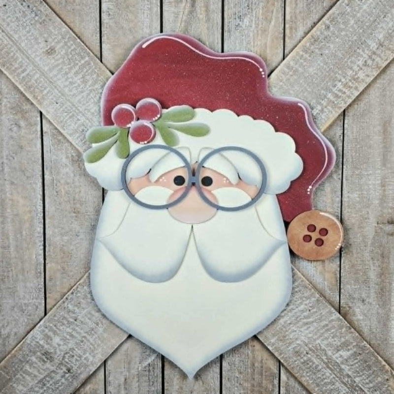 Decorative wooden sign with a Santa Claus face on a wooden background