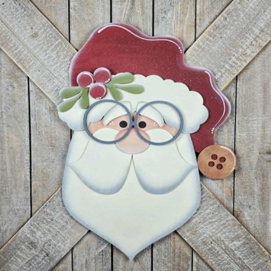 Decorative wooden sign with a Santa Claus face on a wooden background